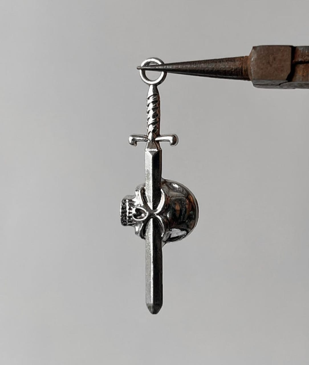 Pierced skull pendent